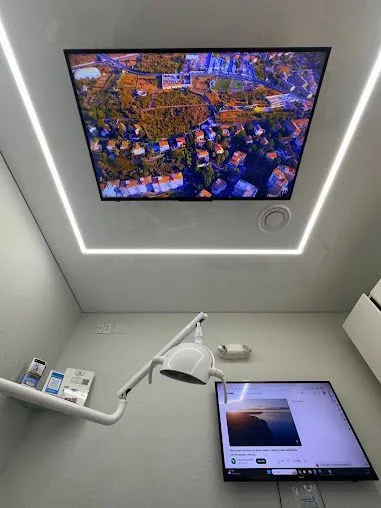 Treatment room with a TV on the ceiling