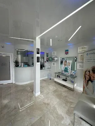 A dental office with a white ceiling and a marble floor.