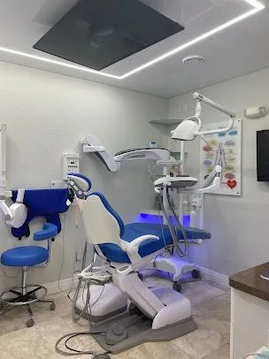 A dental office with a blue and white dental chair.