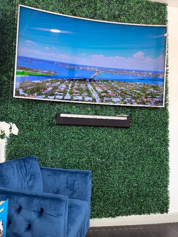 There is a large picture on the wall above the chairs.